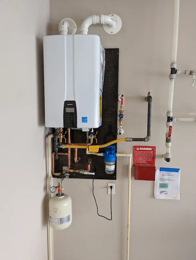 Professional plumber installing copper piping in a Algonac home